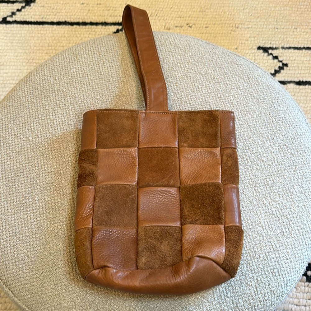 Cognac checkered sling or bucket bag around 11” by 12” with adjustable strap.